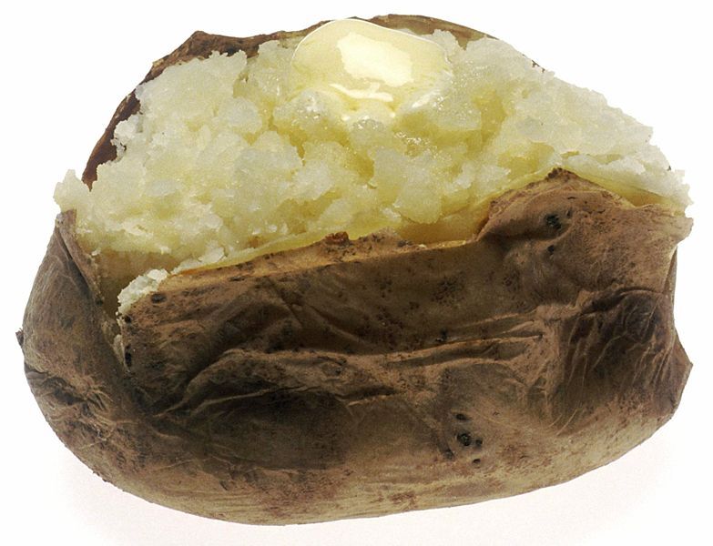 A baked potato topped with butter