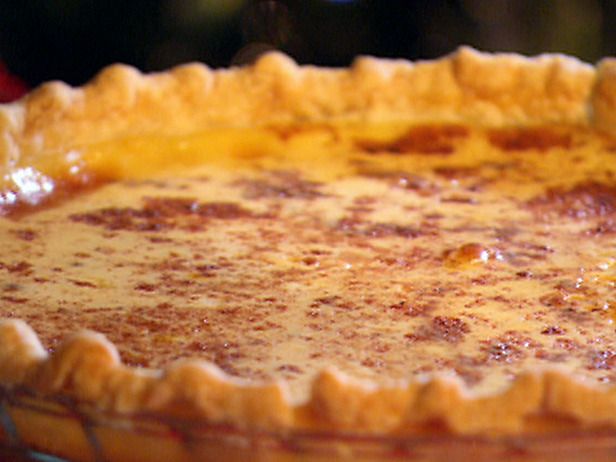 An entire custard pie topped with cinnamon.