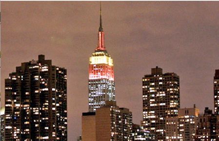 The Empire State Building lit up in red and yellow in honor of Spain's World Cup win