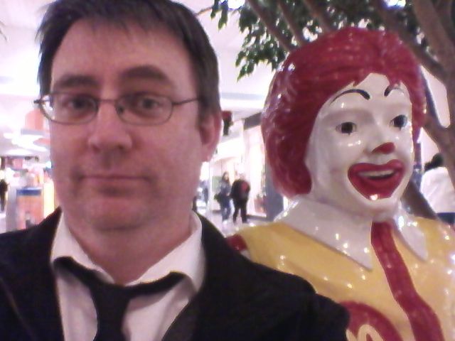 image of Deeky sitting next to a statue of Ronald McDonald